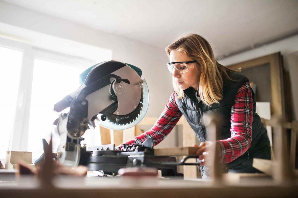woman working with a miter saw